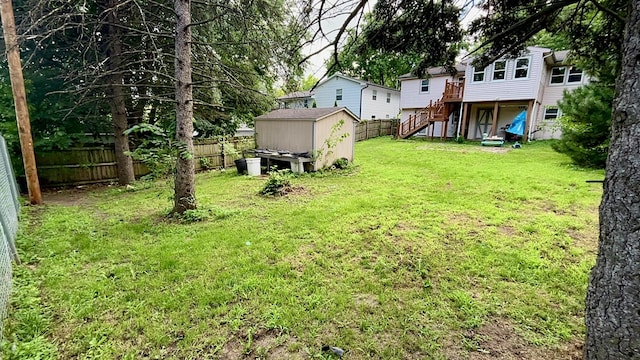 815 Knob Hill Dr, Des Moines, IA 50317 - fenced backyard with a storage shed, stairway, and a wooden deck