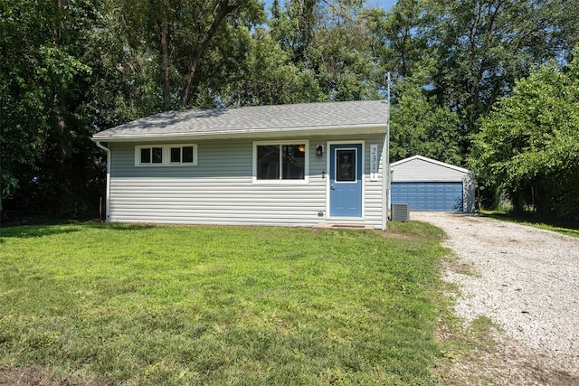 2311 Williams St, Des Moines, IA 50317 - view of front facade with an outbuilding, a front yard, and a detached garage