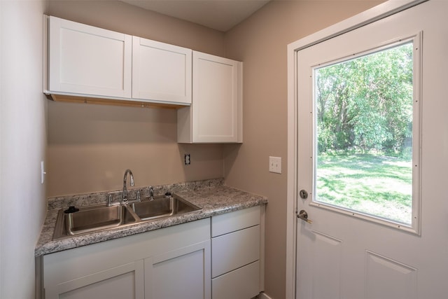 2311 Williams St, Des Moines, IA 50317 - kitchen featuring healthy amount of natural light, white cabinets, and light countertops