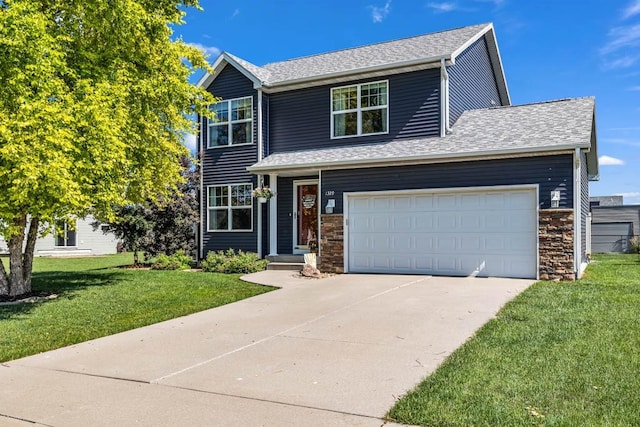 1329 Joshua Cir SE, Bondurant, IA 50035 - traditional-style home featuring driveway, a front yard, a garage, a shingled roof, and stone siding