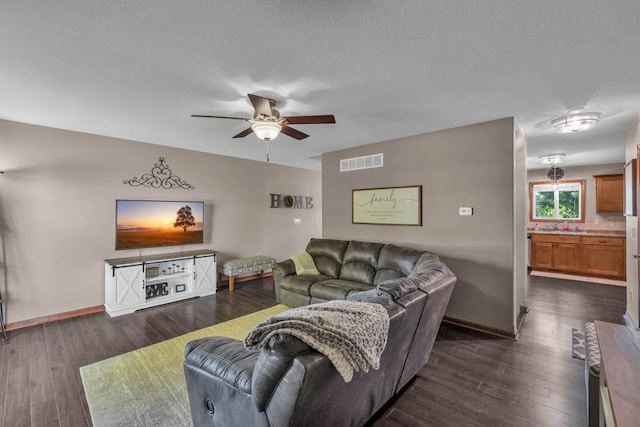 1329 Joshua Cir SE, Bondurant, IA 50035 - living room featuring a ceiling fan and dark wood-type flooring