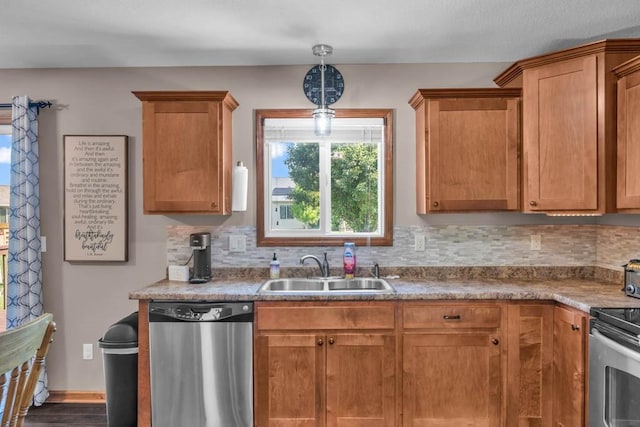 1329 Joshua Cir SE, Bondurant, IA 50035 - kitchen with appliances with stainless steel finishes, tasteful backsplash, pendant lighting, and brown cabinets