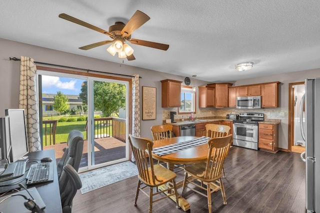 1329 Joshua Cir SE, Bondurant, IA 50035 - dining space featuring dark wood-style floors, ceiling fan, a textured ceiling, and a desk