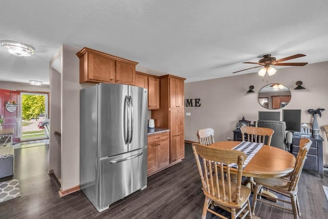 1329 Joshua Cir SE, Bondurant, IA 50035 - dining room featuring ceiling fan, dark wood-style floors, and a textured ceiling