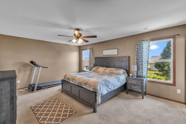 1329 Joshua Cir SE, Bondurant, IA 50035 - carpeted bedroom with baseboards and ceiling fan