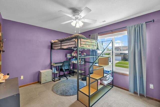 1329 Joshua Cir SE, Bondurant, IA 50035 - bedroom featuring carpet flooring, an office area, ceiling fan, and a textured ceiling