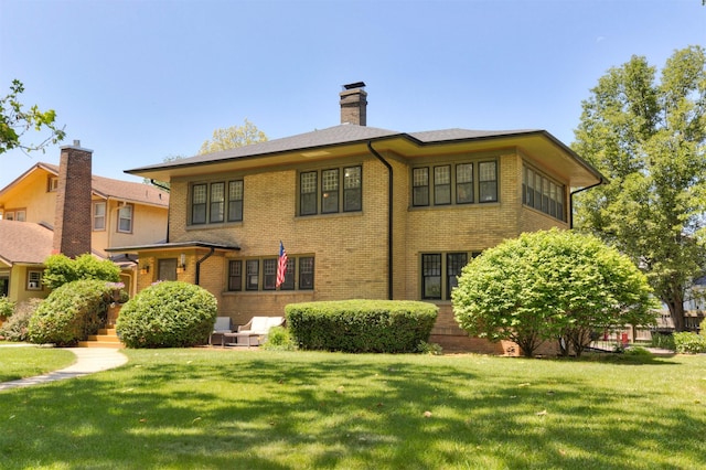 642 Polk Blvd, Des Moines, IA 50312 - view of front facade featuring brick siding, a chimney, and a front yard