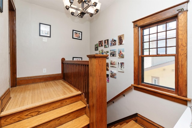 642 Polk Blvd, Des Moines, IA 50312 - stairway featuring a chandelier and hardwood / wood-style flooring