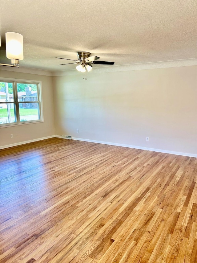 2327 Glenbrook Dr, Des Moines, IA 50316 - unfurnished room featuring light wood-style flooring, crown molding, a textured ceiling, and ceiling fan