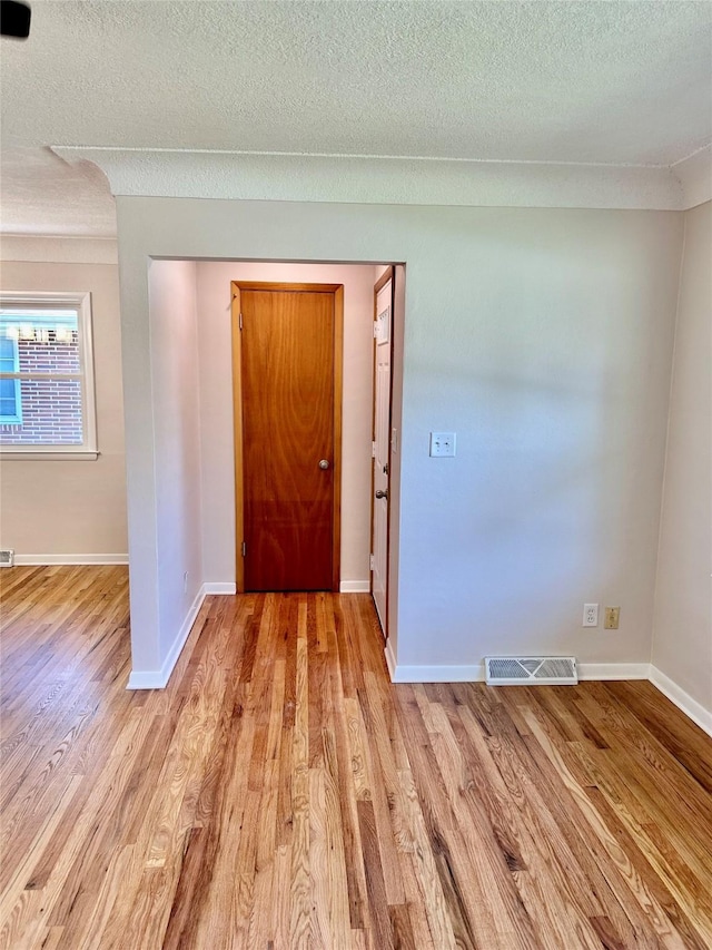 2327 Glenbrook Dr, Des Moines, IA 50316 - entrance foyer with light wood-style flooring and a textured ceiling