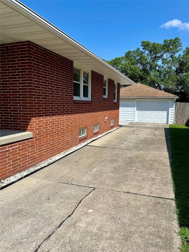 2327 Glenbrook Dr, Des Moines, IA 50316 - view of side of home featuring brick siding, an outdoor structure, and a detached garage