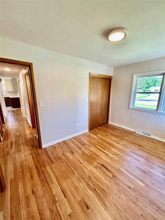 2327 Glenbrook Dr, Des Moines, IA 50316 - spare room featuring light wood-style floors and baseboards