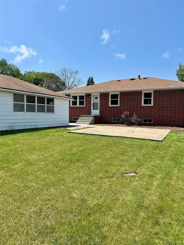 2327 Glenbrook Dr, Des Moines, IA 50316 - rear view of house with a yard, a patio area, and brick siding