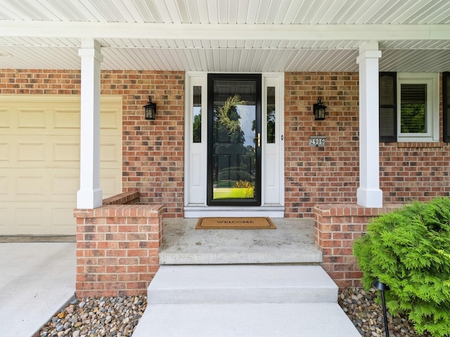 2906 Watrous Ave, Des Moines, IA 50321 - view of exterior entry featuring covered porch and brick siding
