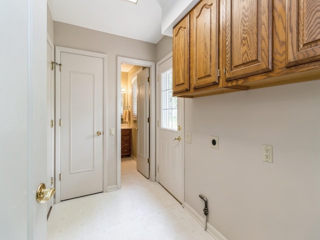 2906 Watrous Ave, Des Moines, IA 50321 - washroom with electric dryer hookup, cabinet space, and light flooring