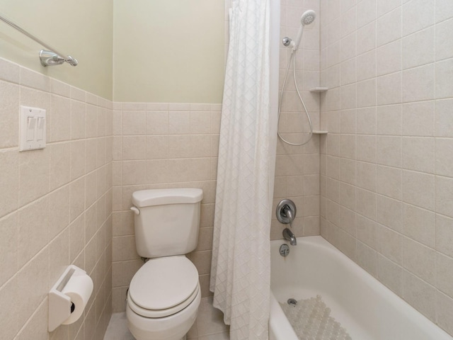 2906 Watrous Ave, Des Moines, IA 50321 - bathroom featuring shower / bath combo with shower curtain and tile walls