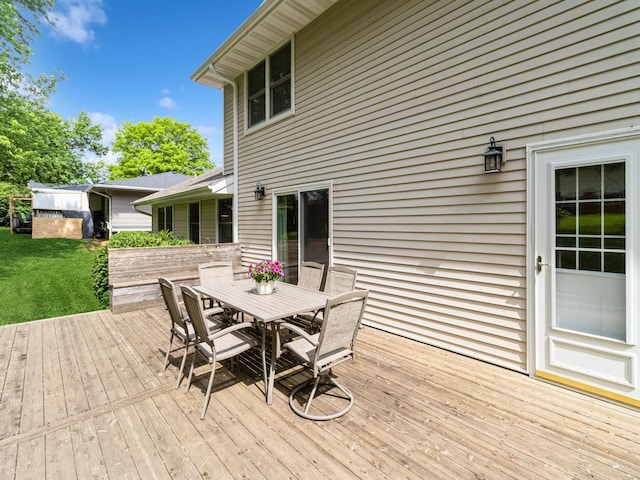 2906 Watrous Ave, Des Moines, IA 50321 - wooden deck featuring outdoor dining area and a lawn