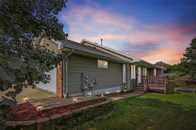 711 Kitterman Cir, Norwalk, IA 50211 - back of house with a yard, a wooden deck, and brick siding