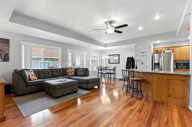 711 Kitterman Cir, Norwalk, IA 50211 - living room featuring ceiling fan, wood-type flooring, recessed lighting, and a raised ceiling