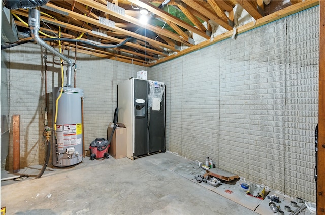 711 Kitterman Cir, Norwalk, IA 50211 - below grade area featuring gas water heater and freestanding refrigerator