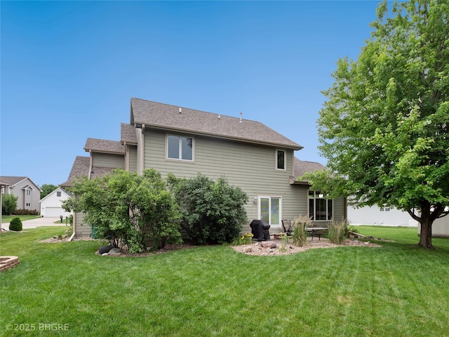 4710 76th St, Urbandale, IA 50322 - back of property with a yard and a shingled roof