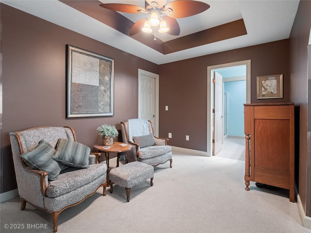 4710 76th St, Urbandale, IA 50322 - living area with ceiling fan, light colored carpet, and a raised ceiling