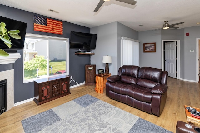 2323 E Porter Ave Unit 36, Des Moines, IA 50320 - living room featuring ceiling fan, wood finished floors, and a tile fireplace