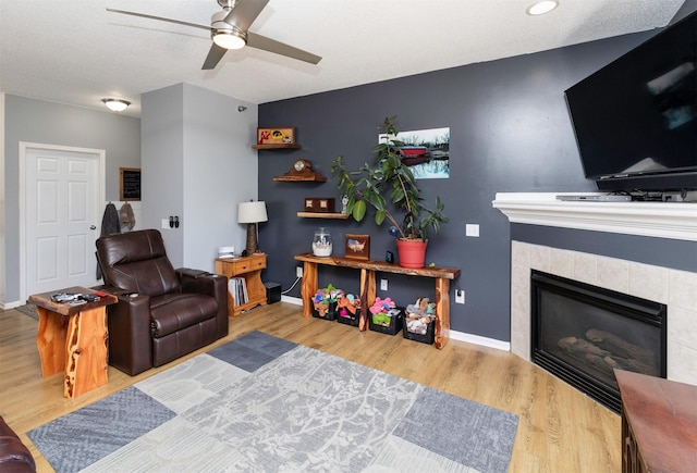 2323 E Porter Ave Unit 36, Des Moines, IA 50320 - living area with a ceiling fan, wood finished floors, and a fireplace