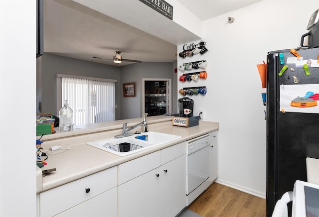2323 E Porter Ave Unit 36, Des Moines, IA 50320 - kitchen featuring dishwasher, freestanding refrigerator, light wood-style floors, and light countertops