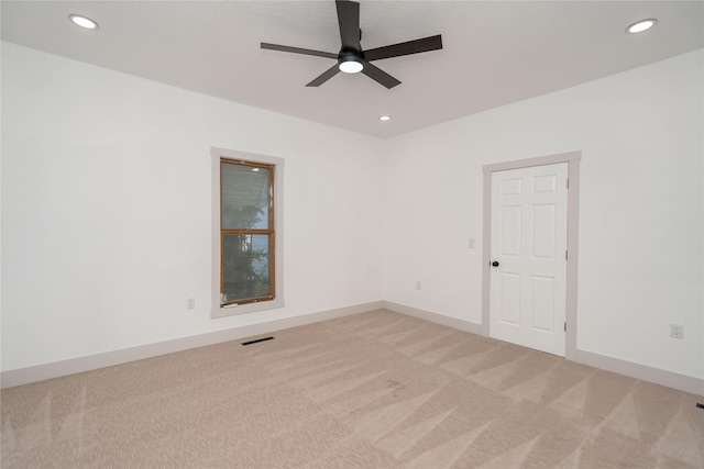 600 S 3rd Ave W, Newton, IA 50208 - unfurnished room featuring light colored carpet, ceiling fan, and recessed lighting