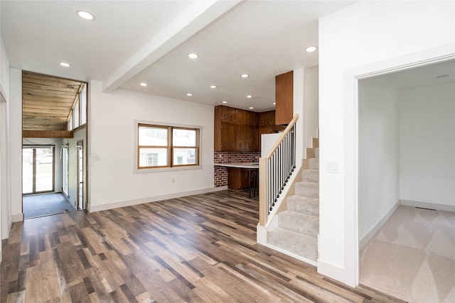 600 S 3rd Ave W, Newton, IA 50208 - unfurnished living room with recessed lighting, stairs, wood finished floors, and beam ceiling