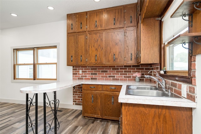 600 S 3rd Ave W, Newton, IA 50208 - kitchen with brown cabinets, light countertops, tasteful backsplash, recessed lighting, and wood finished floors