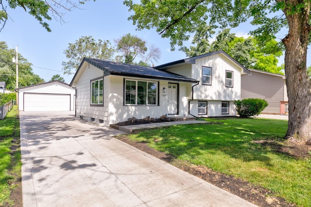 4132 E 24th Ct, Des Moines, IA 50317 - split level home with an outbuilding, a front lawn, and a detached garage