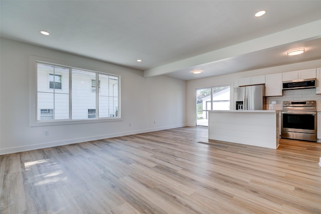 4132 E 24th Ct, Des Moines, IA 50317 - unfurnished living room with light wood-style flooring and recessed lighting