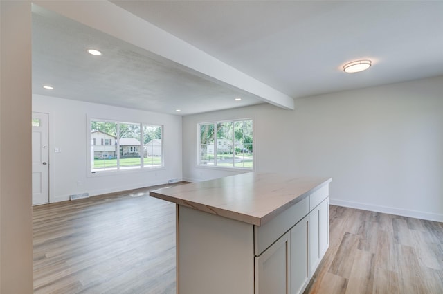 4132 E 24th Ct, Des Moines, IA 50317 - kitchen featuring light wood finished floors, a kitchen island, recessed lighting, open floor plan, and light countertops