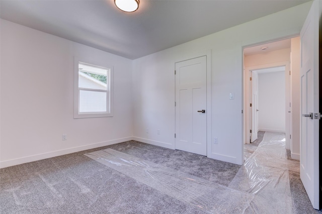 4132 E 24th Ct, Des Moines, IA 50317 - unfurnished bedroom featuring light carpet and baseboards