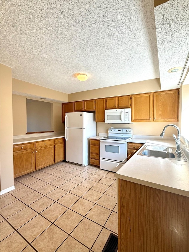 2519 W 1st St, Ankeny, IA 50023 - kitchen featuring white appliances, a textured ceiling, light countertops, brown cabinetry, and light tile patterned floors