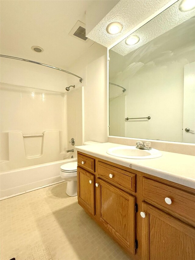 2519 W 1st St, Ankeny, IA 50023 - bathroom with shower / bathtub combination, vanity, a textured ceiling, and tile patterned floors
