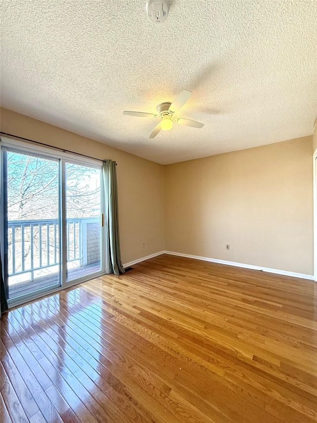 2519 W 1st St, Ankeny, IA 50023 - spare room with a textured ceiling, hardwood / wood-style floors, and a ceiling fan