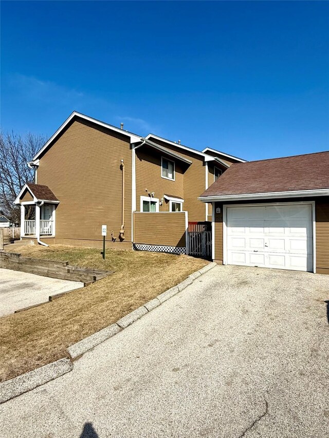 2519 W 1st St, Ankeny, IA 50023 - view of side of property with asphalt driveway and an attached garage