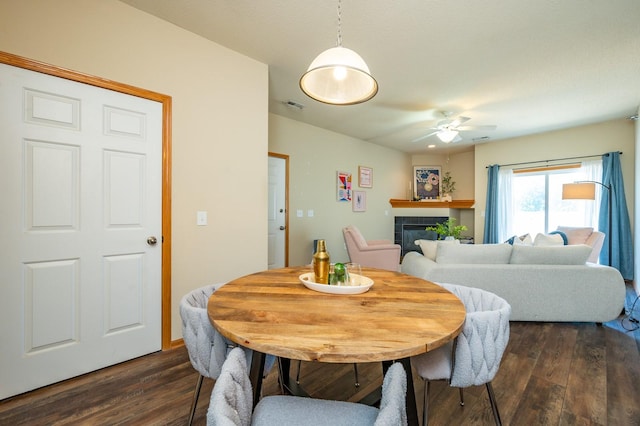 8601 Westown Pkwy Unit 18211, West Des Moines, IA 50266 - dining space featuring a ceiling fan, dark wood-style flooring, and a fireplace