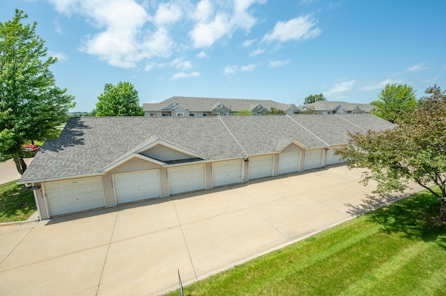 8601 Westown Pkwy Unit 18211, West Des Moines, IA 50266 - view of property with community garages, a shingled roof, and a residential view