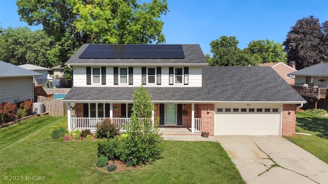 608 E 15th St N, Newton, IA 50208 - traditional-style home featuring a porch, brick siding, and an attached garage