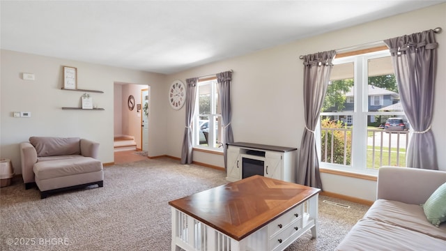 608 E 15th St N, Newton, IA 50208 - carpeted living area with healthy amount of natural light and stairs