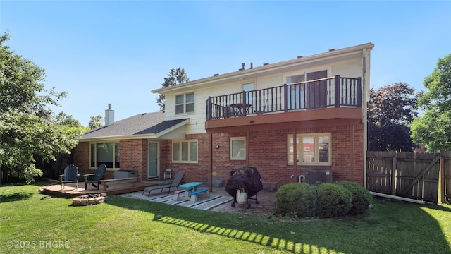 608 E 15th St N, Newton, IA 50208 - rear view of property featuring a balcony, brick siding, a patio, and a chimney