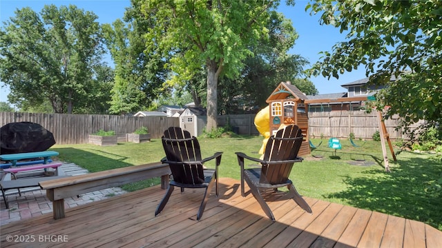 608 E 15th St N, Newton, IA 50208 - deck with a playground, a fenced backyard, and a storage unit