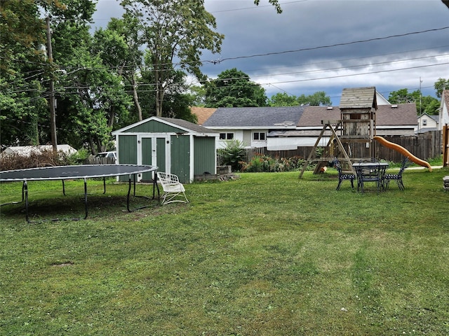 1096 Buchanan St, Des Moines, IA 50316 - fenced backyard featuring a trampoline, a shed, and a playground