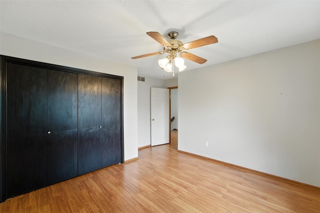 1228 64th St, West Des Moines, IA 50266 - unfurnished bedroom featuring light wood-type flooring, a closet, and ceiling fan