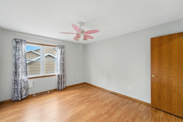1228 64th St, West Des Moines, IA 50266 - spare room featuring light wood-style floors and ceiling fan