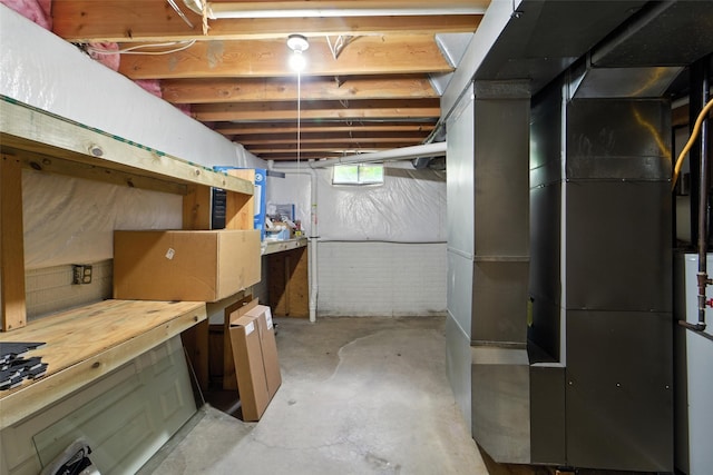 1228 64th St, West Des Moines, IA 50266 - basement featuring a workshop area and heating unit